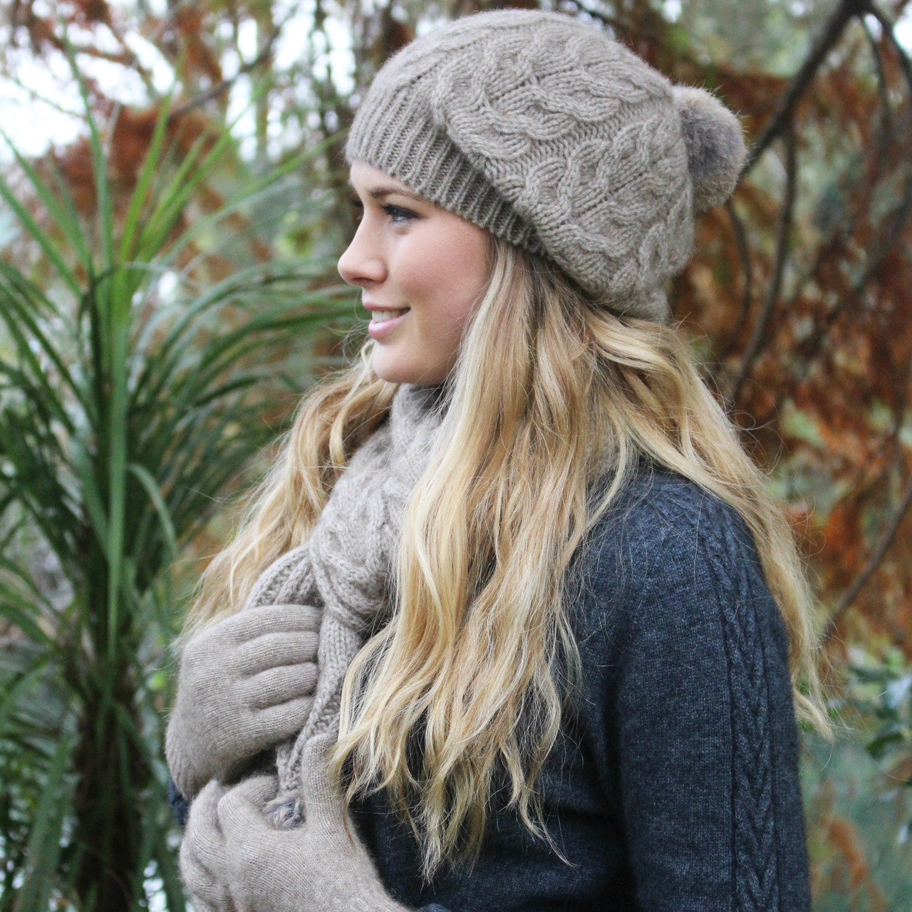 Natural-Blonde woman wearing beanie, scarf and gloves. 