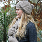Natural-Blonde woman wearing beanie, scarf and gloves. 