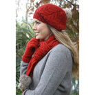 Blonde woman wearing red beanie, red scarf and red gloves. 