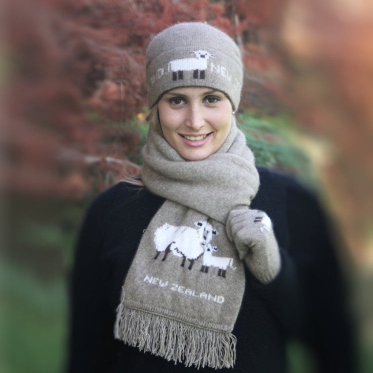 Woman wearing beanie and scarf with sheep picture