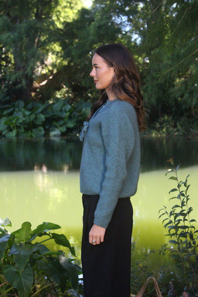 Woman wearing the Lothlorian - Merino & Possum Fuse Tie Jacket (9972) in the colour Sage.