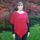 Blonde woman wearing poncho. Colour Raspberry