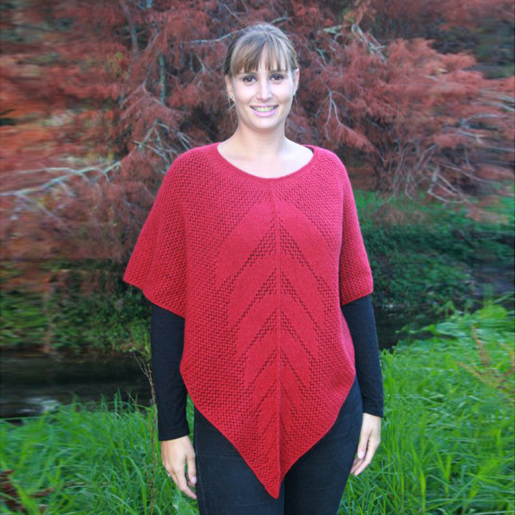 Blonde woman wearing poncho. Colour Raspberry