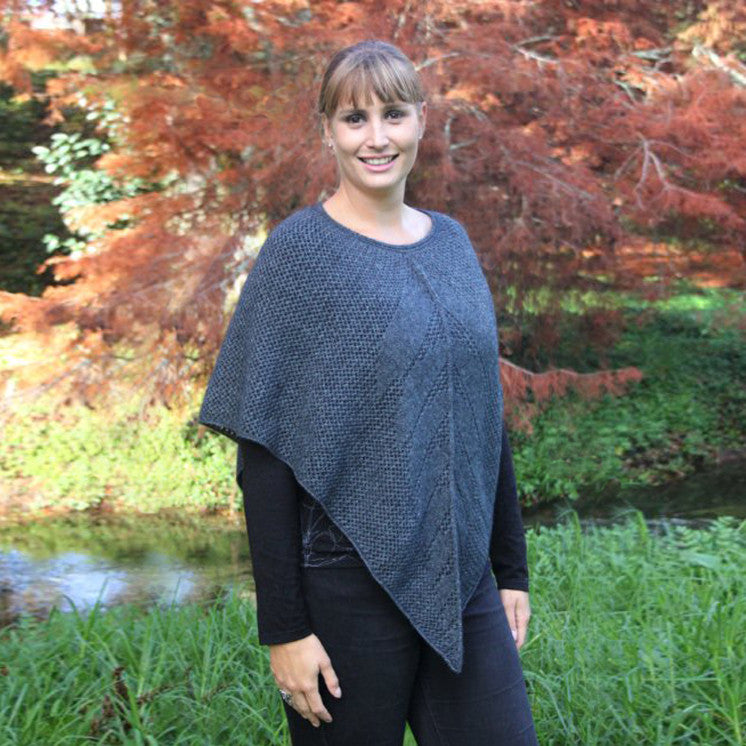 Blonde woman wearing poncho. Colour Charcoal
