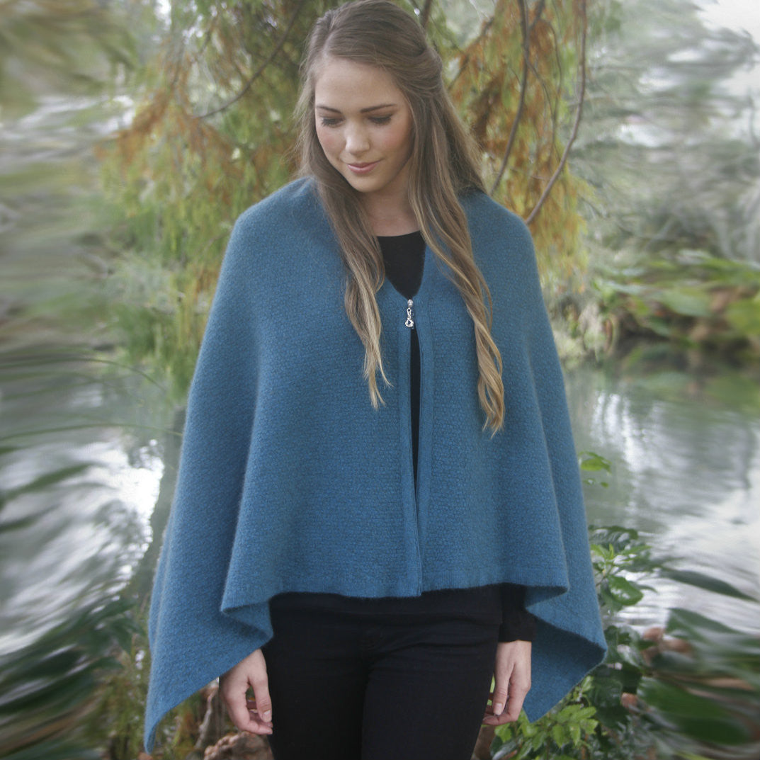 Woman with half zipped zippered wrap in colour Lagoon