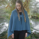 Woman with half zipped zippered wrap in colour Lagoon