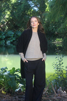Woman wearing Lothlorian - Merino & Possum Brando Wrap (9993) in the colour Black.