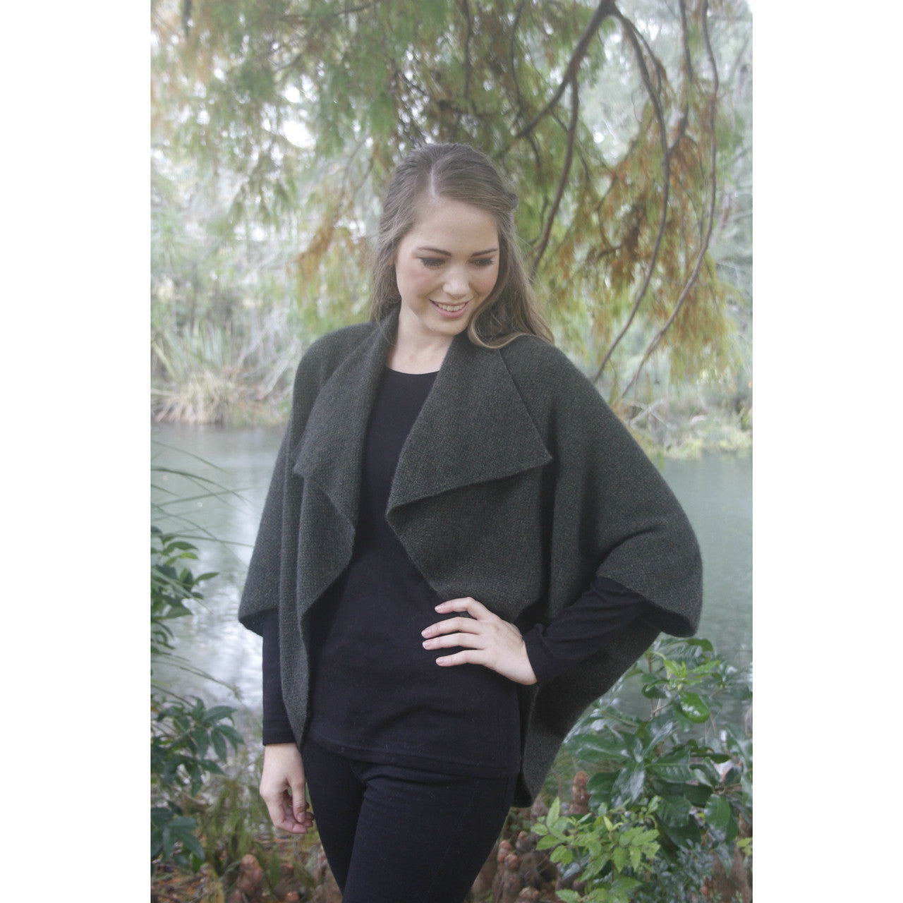 Woman wearing Takahe cape in colour Charcoal