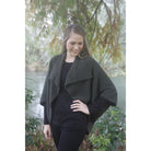 Woman wearing Takahe cape in colour Charcoal