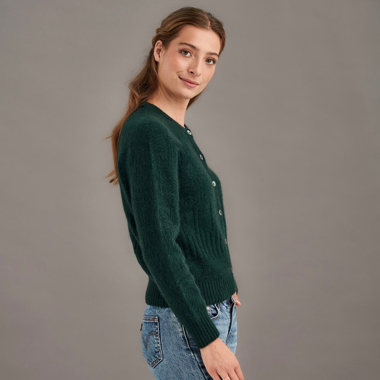 Woman wearing McDonald - Merino & Possum Patchwork Cardigan (5062) in the colour Forest.
