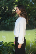 Woman wearing the Lothlorian - Alpaca Chime Jumper (ALP079) in the colour Natural.