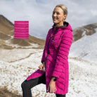Woman wearing Moke - Arnie Reversible Packable Down Coat (ARNIE) in colour Black/Rose Violet on hill with snow in backgroumd.