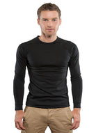 Man wearing Merino long black sleeve thermal top.
