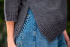 Woman wearing Country Laine - Slant Jumper (CL0115-IND2026) in the colour Dark Grey.
