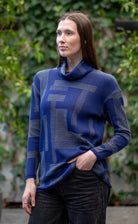 Woman wearing Country Laine -  Cubist Jumper (CL0123L-IND2026) in the colour Atlantic/Dark Grey.