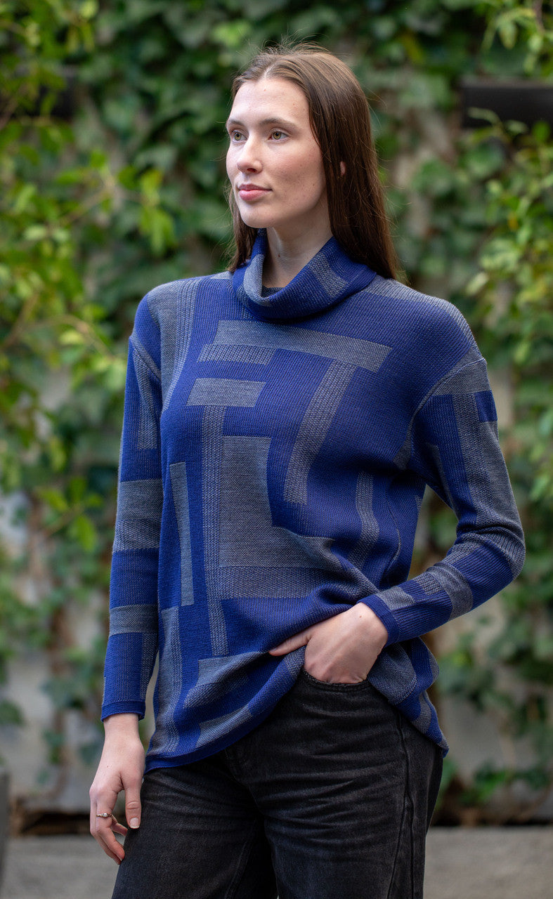 Woman wearing Country Laine -  Cubist Jumper (CL0123L-IND2026) in the colour Atlantic/Dark Grey.