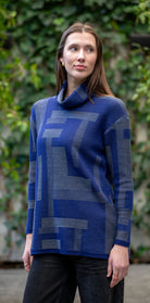 Woman wearing Country Laine -  Cubist Jumper (CL0123L-IND2026) in the colour Atlantic/Dark Grey.
