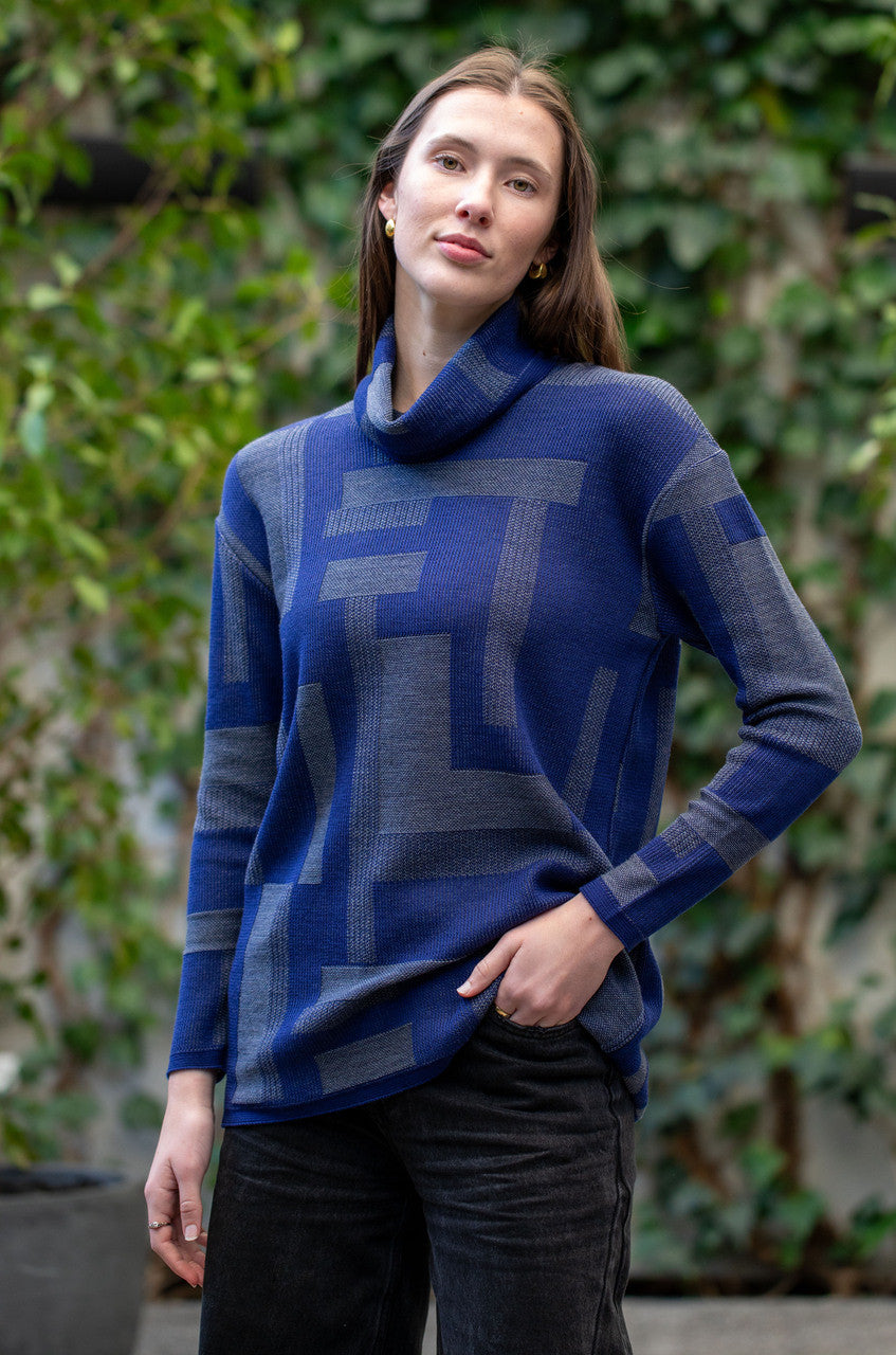 Woman wearing Country Laine -  Cubist Jumper (CL0123L-IND2026) in the colour Atlantic/Dark Grey.