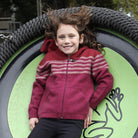 Girl leaning back wearing fuchsia colour striped hoodie.