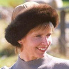 Woman wearing a Tan coloured Four Peaks Classic Panelled Lambskin & Possum Fur Hat.