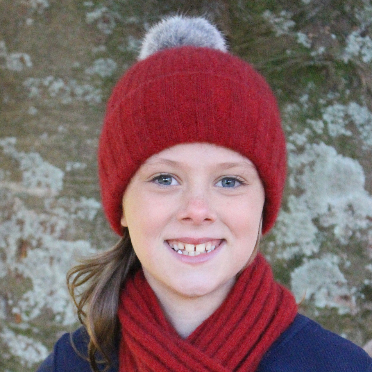 Child wearing beanie. Colour Red
