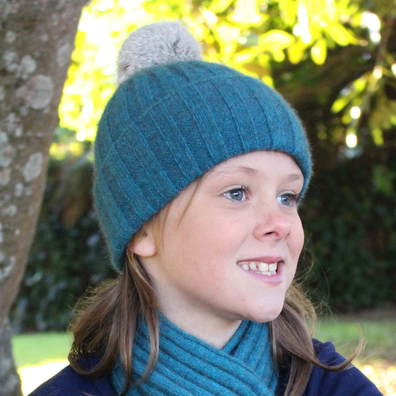 Child wearing beanie. Colour Teal