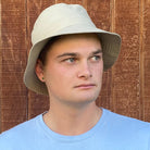 Man wearing light sand coloured Hydroex rain hat.