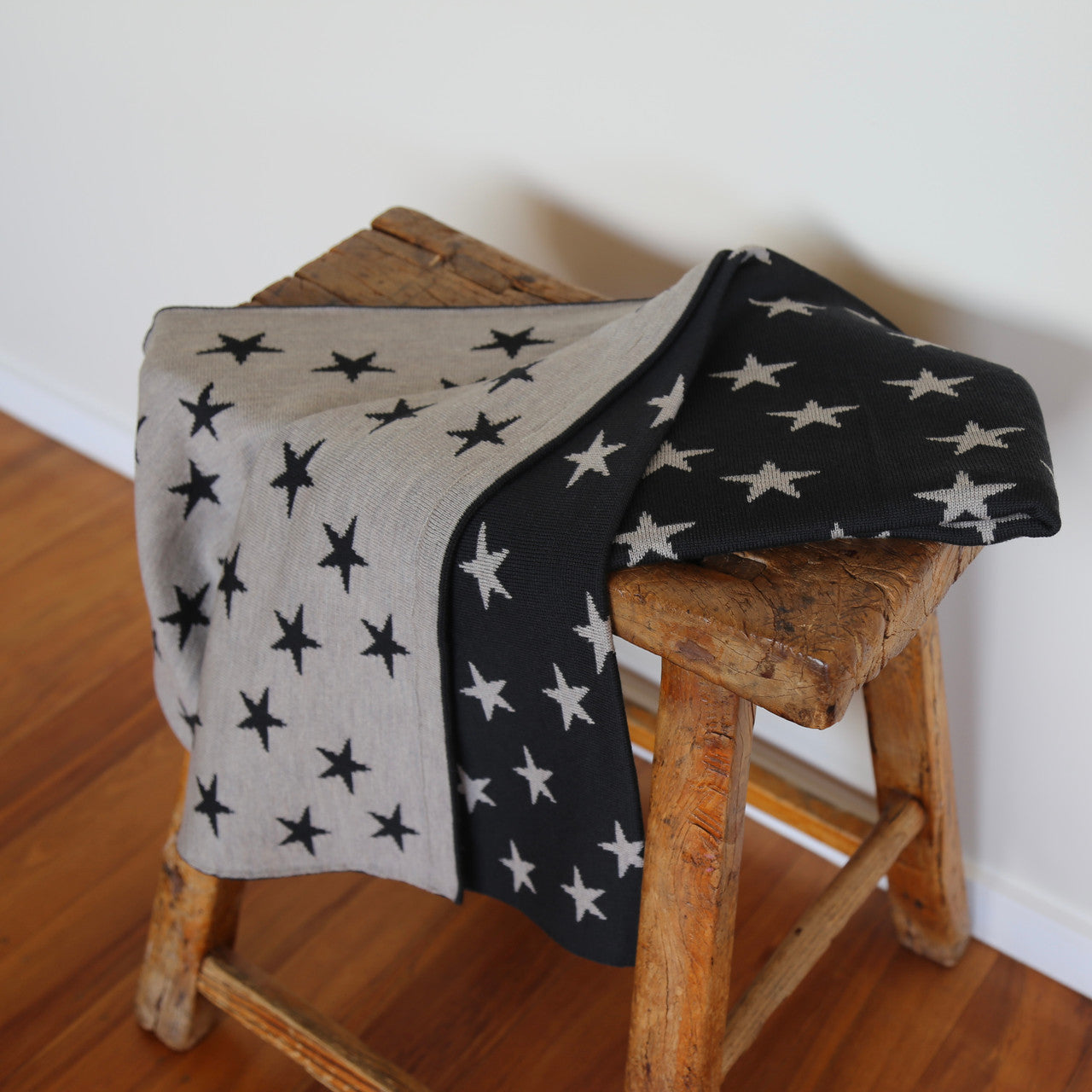 Babies Cot Blanket in colour Granite & Chateau on chair.