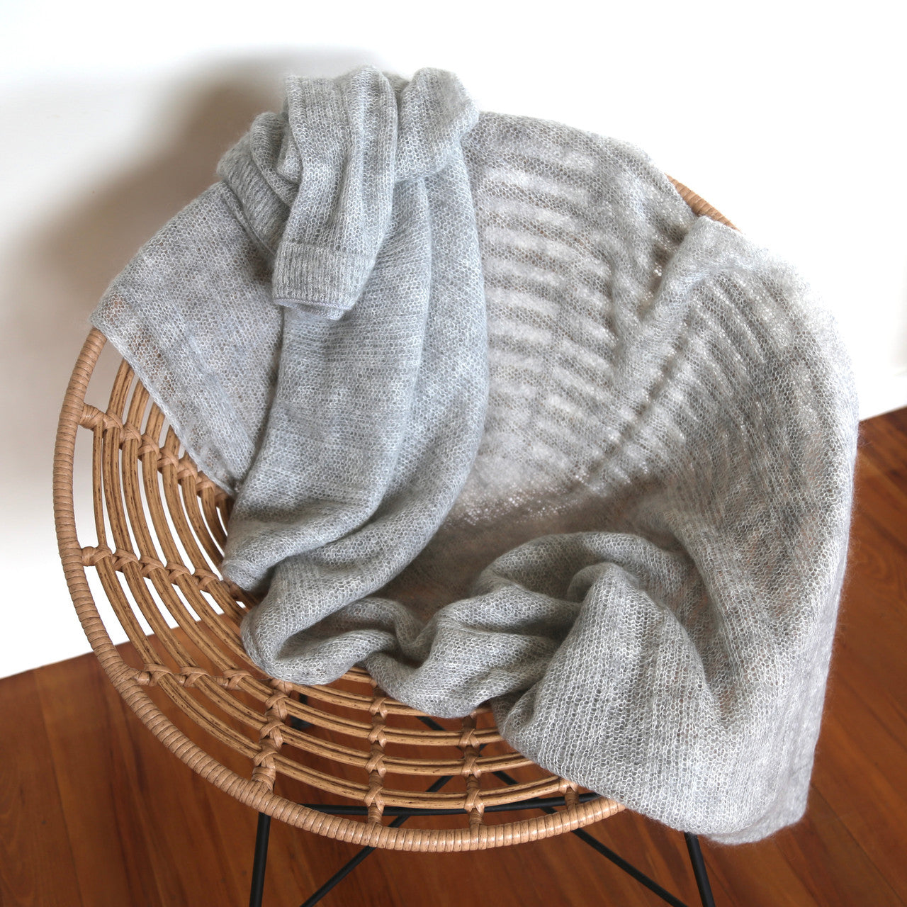 Silver-coloured Knight Mohair Throw draped over chair.