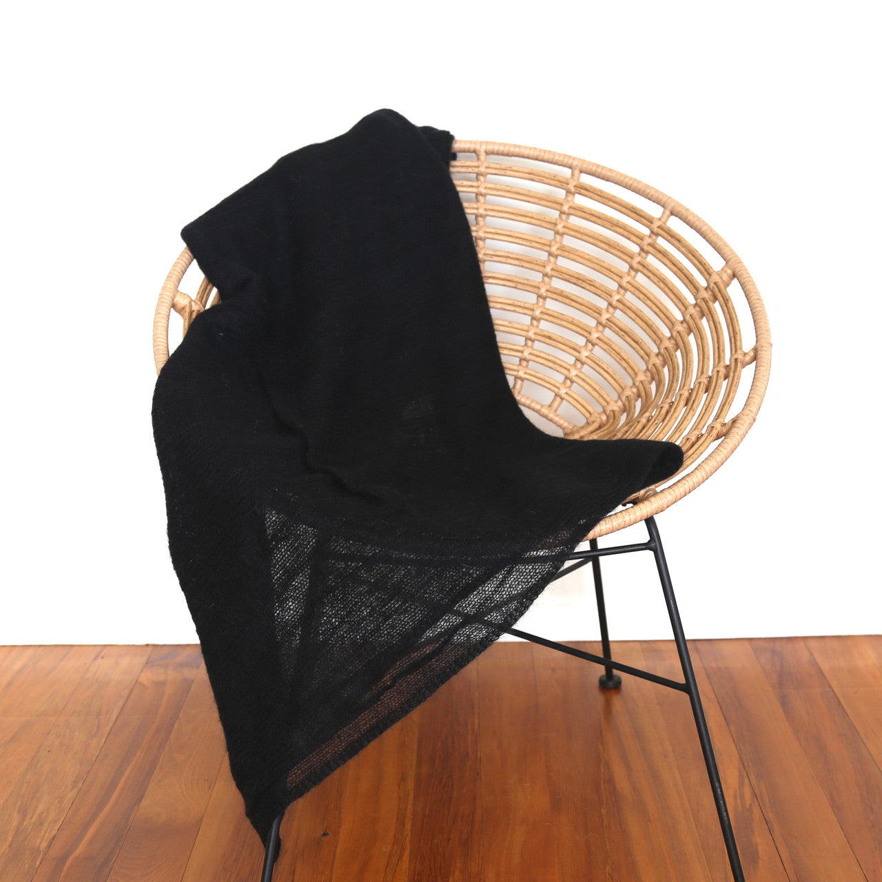 Black-coloured Knight Mohair Throw draped over chair.