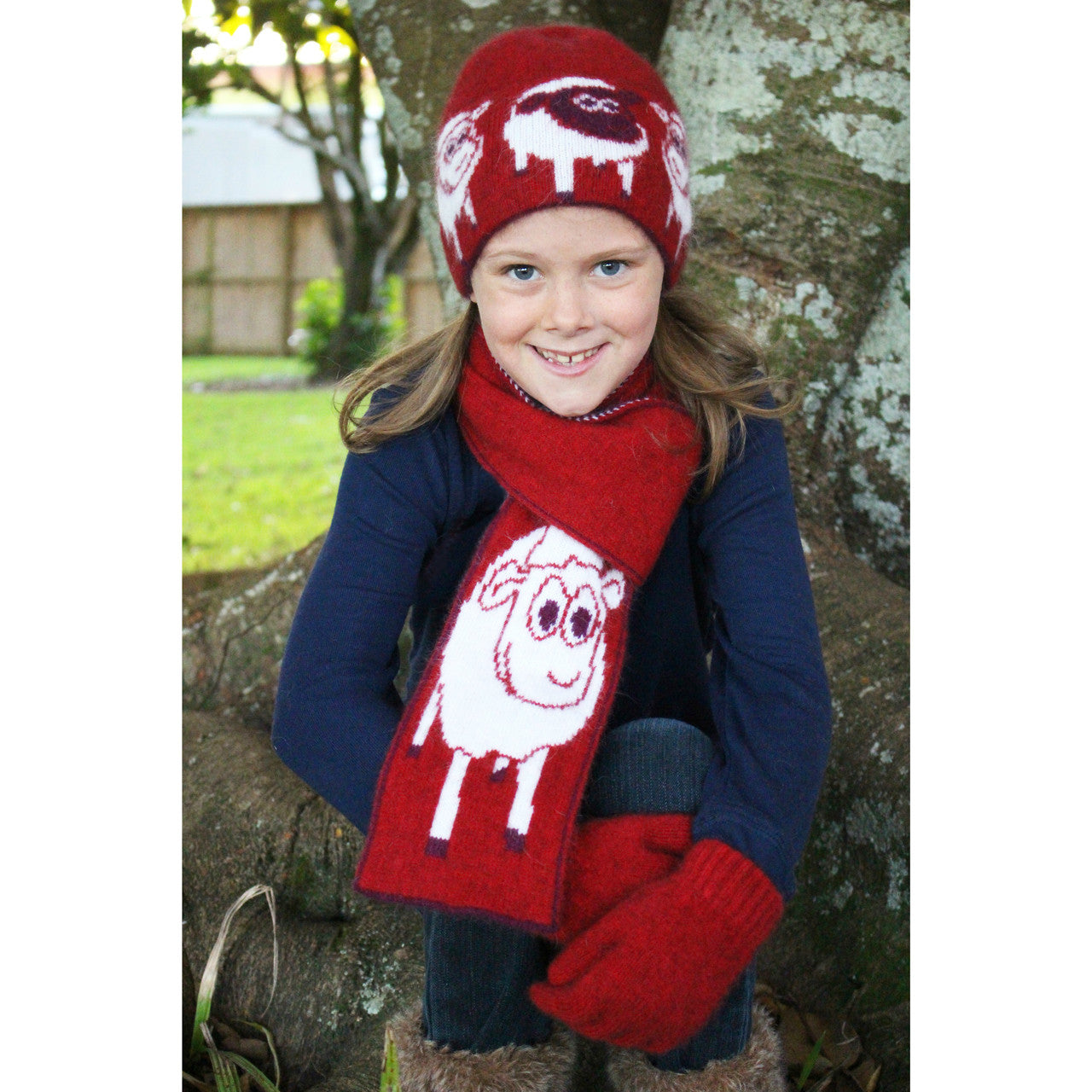 Girl sitting wearing Beanie in colour red.
