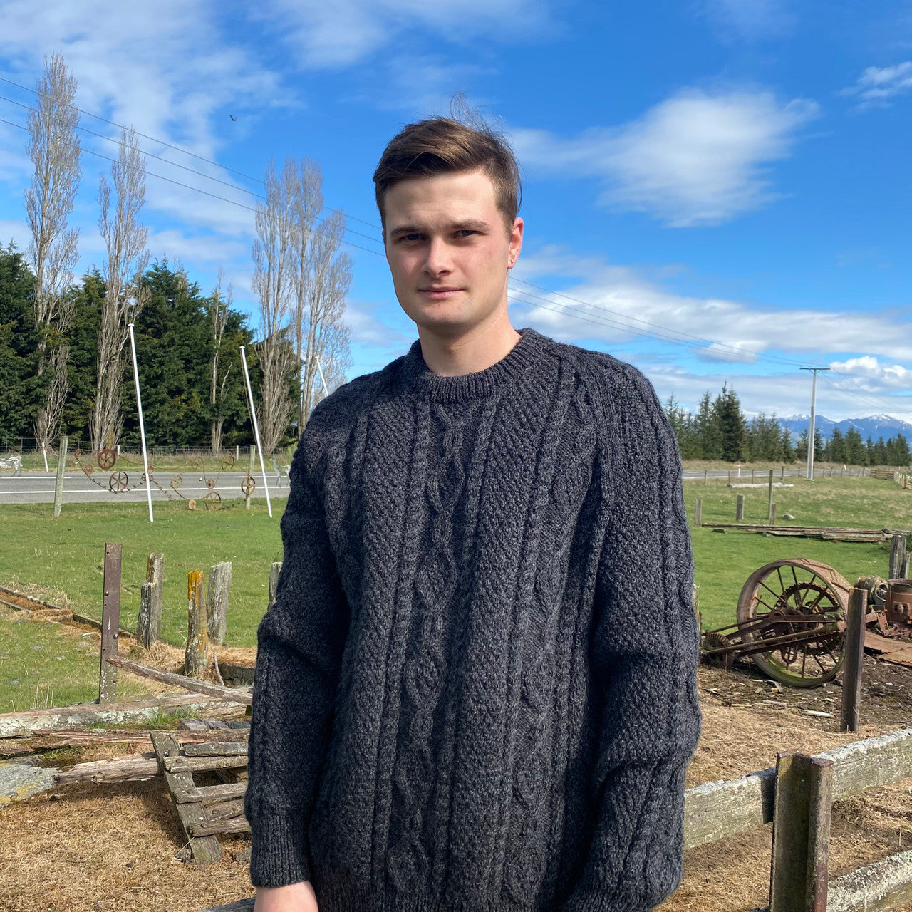 Man wearing Lesley Unisex Aran Wool sweater in the colour Charcoal.