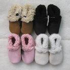 Babies’ lambskin booties in various colours.