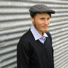 Man wearing hunston black coloured Traditional Cheesecutter Deluxe hat.