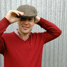 Man wearing olive coloured Bingley Check Lambswool Tweed Cheesecutter hat.