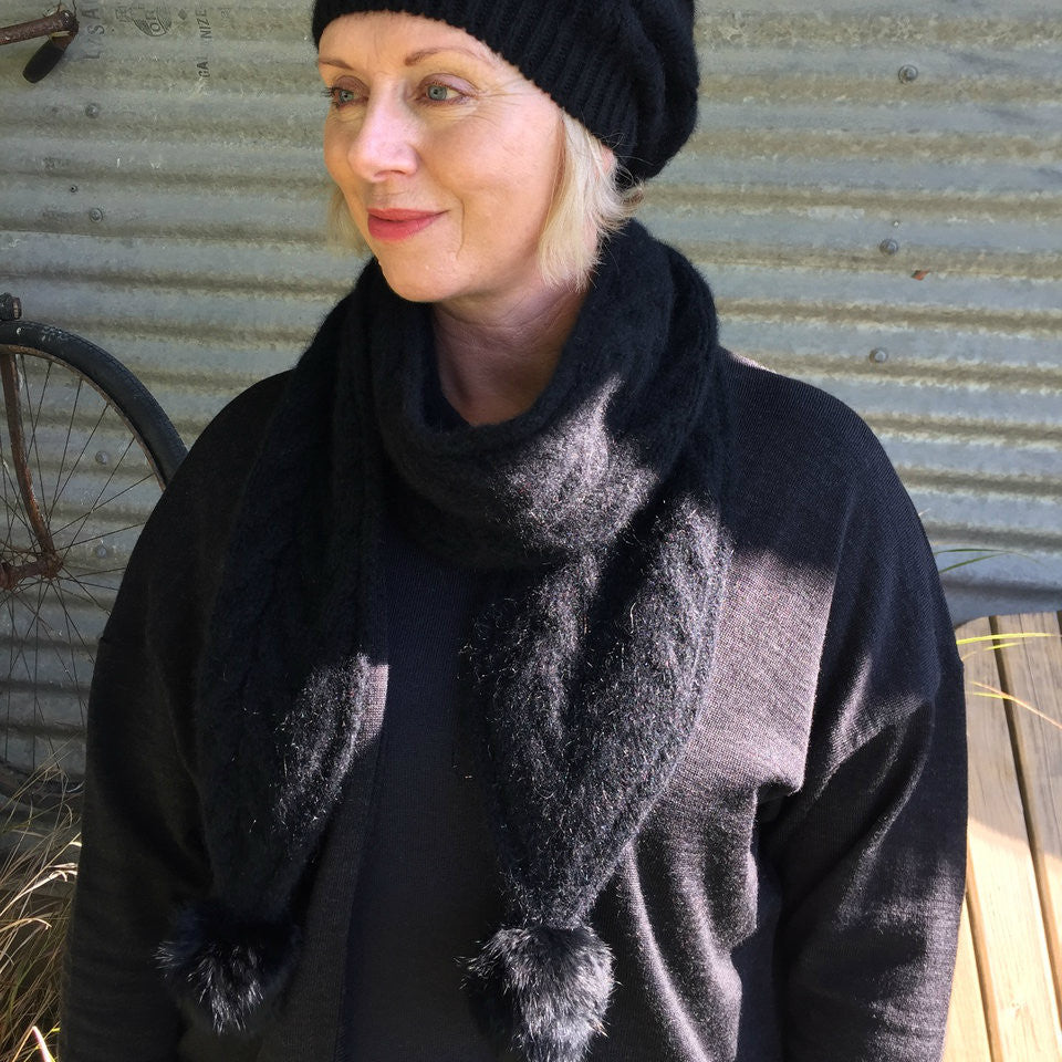 Black-Woman wearing black beanie and black outfit.