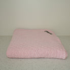 Pink coloured baby eyelet blanket.