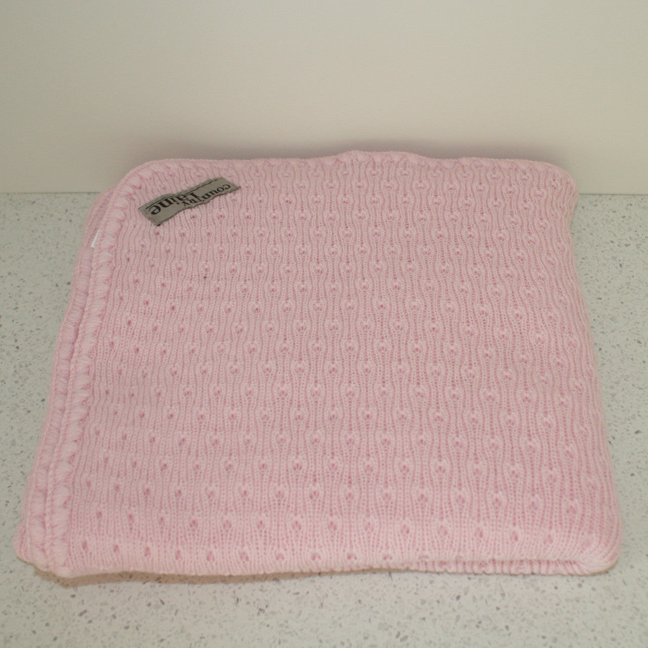 Pink coloured baby blanket.