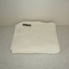 White coloured baby blanket.