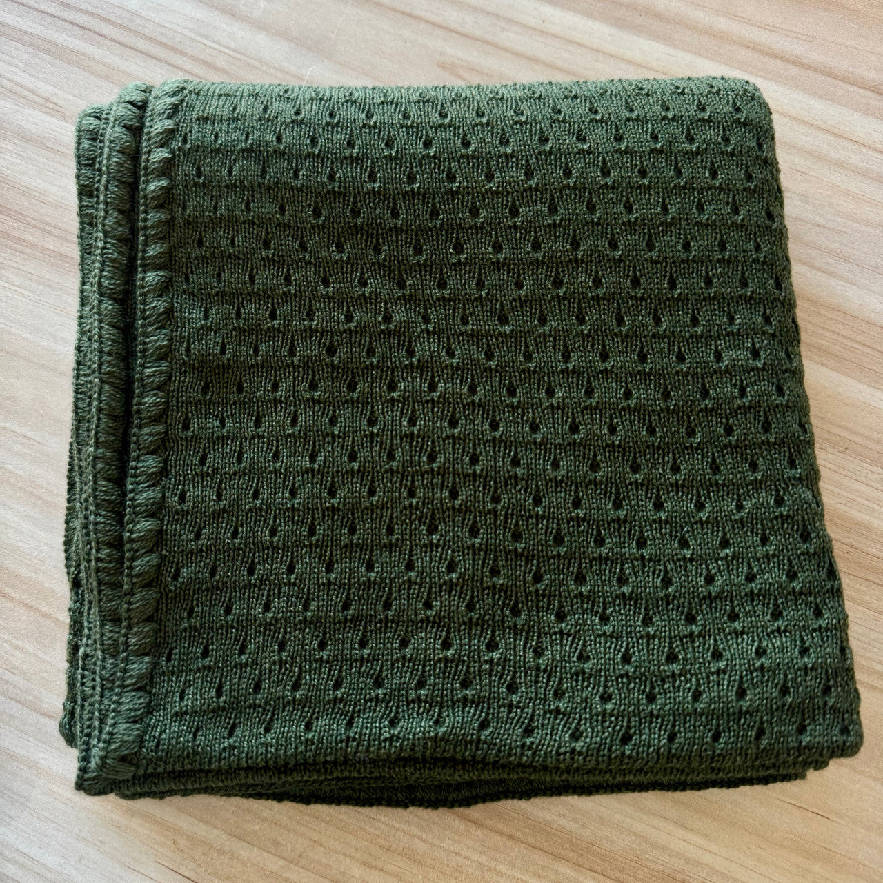 Moss coloured baby blanket.