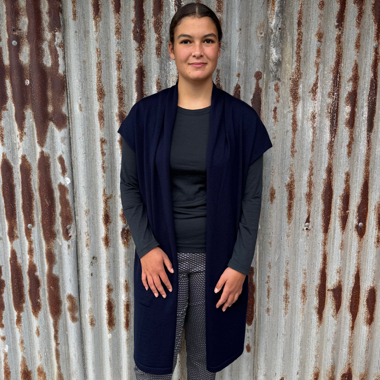 Woman wearing Country Laine - Merino Longline Cap Sleeve Cardigan (CL069) in the colour Navy