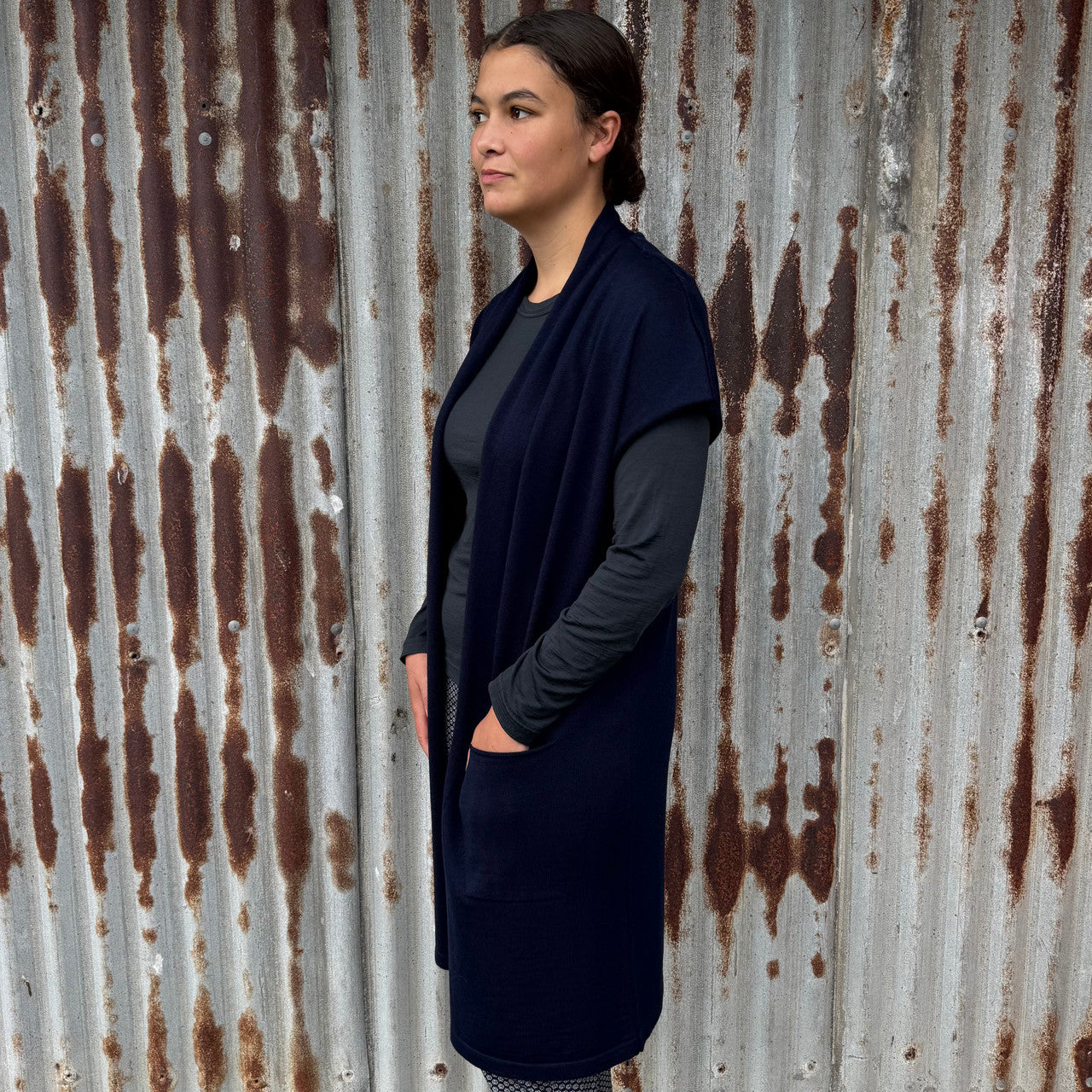 Woman wearing Country Laine - Merino Longline Cap Sleeve Cardigan (CL069) in the colour Navy