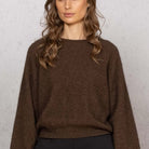 Woman wearing Noble Wilde - Merino & Possum Bellow Sleeve Top in the colour Tobago.