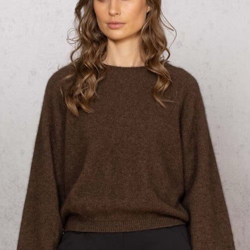 Woman wearing Noble Wilde - Merino & Possum Bellow Sleeve Top in the colour Tobago.
