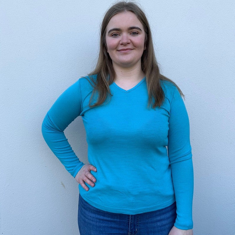 Woman wearing vee neck top in colour Opal