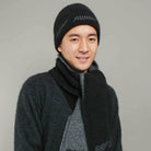 Man standing wearing a black-coloured Koru merino and possum NZ Supporters Silver Fern Beanie.