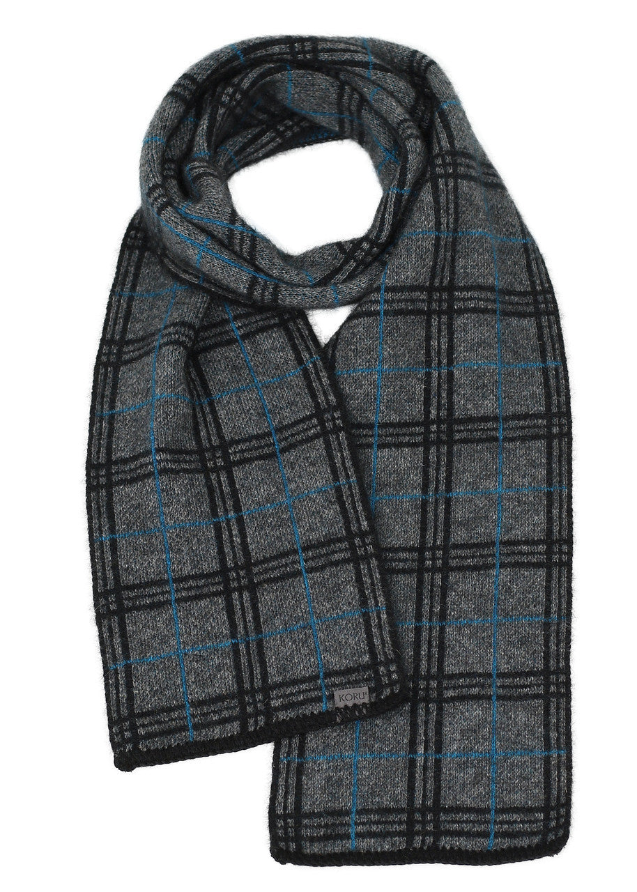 A grey, black, and pacific-coloured Koru merino and possum Tartan Scarf.