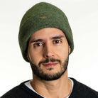 A man wearing an Moss-coloured Koru Merino and Possum Plain Beanie.