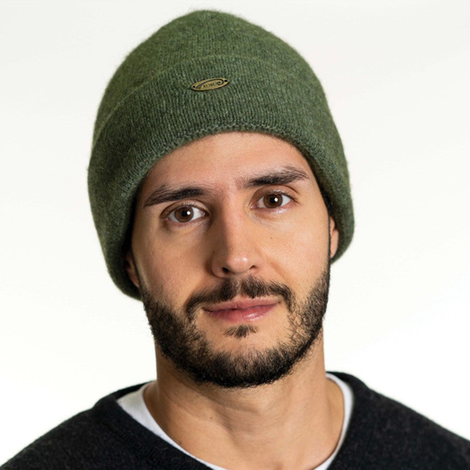 A man wearing an Moss-coloured Koru Merino and Possum Plain Beanie.