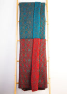 Two Koru Merino and Possum Patterned Throws draped over wooden ladder.